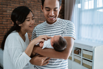 happy young parent when relaxing with little daughter in the home