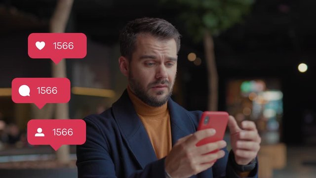 Serious sad young man in shopping mall hold uses smartphone typing social media icons with like comment follower counter quick decrease blogger influencer internet blog slow motion
