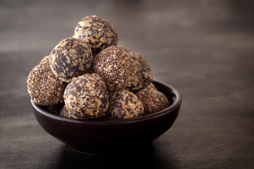 Healthy organic energy granola bites with nuts, cacao, banana and honey - sports food, vegetarian raw snack