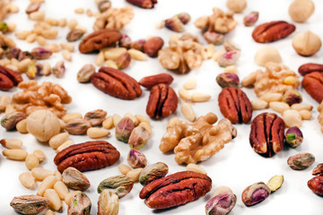 Background of different nuts. Pecan, macadamia, pistachio, pine nuts, walnuts.