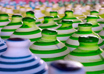 closeup Colorful pottery line up together on floor in selective focus one on the middle, Bahrain.