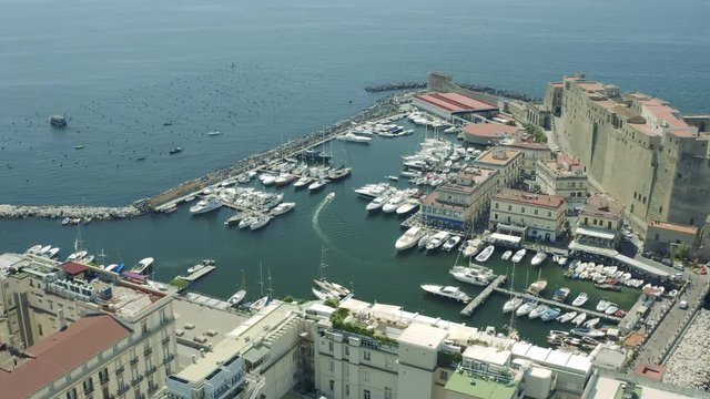 Aerial view of the colourful city of Naples and Ovo Castle on a sunny day, Italy