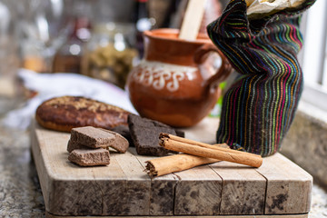 Traditional Mexican chocolate and spices on a wooden table 