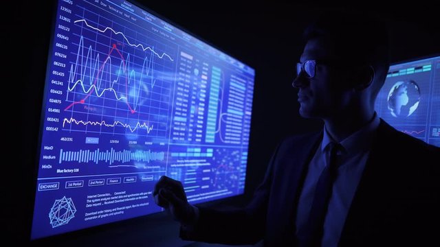 The man working on a blue sensor monitor