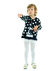 The little girl stretches her arms forward.