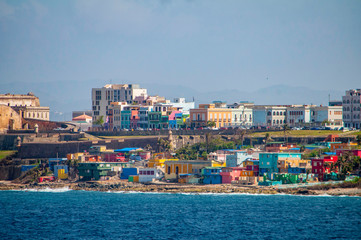 Colorful houses line the hill side overlooking the beach in San Juan, Puerto Rico.