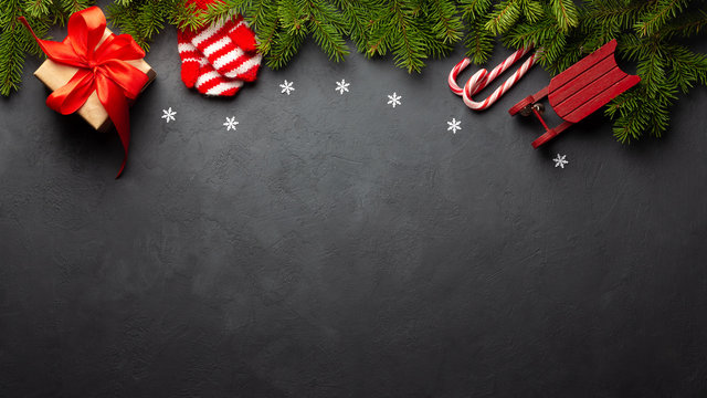 Christmas or New Year dark background. Fir tree and xmas decor. Top view with copy space.