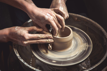 Creating vase of white clay close-up. Master crock.