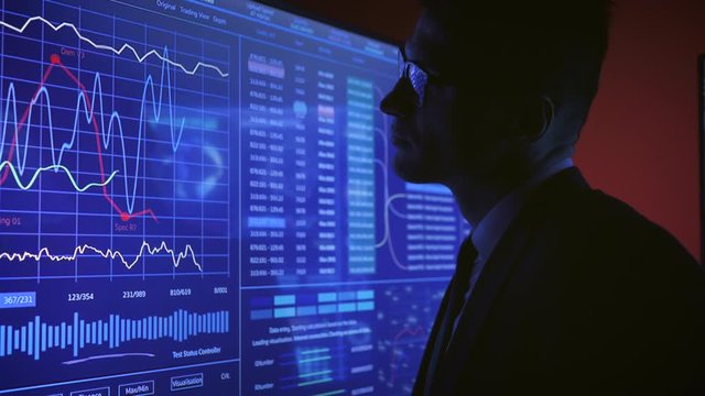 The engineer working on sensor screen in the dark space