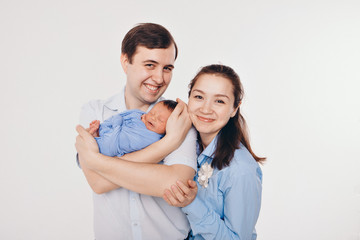 the concept of a healthy lifestyle, the protection of children, shopping - baby in the arms of the mother and wather. Woman and man holding a child