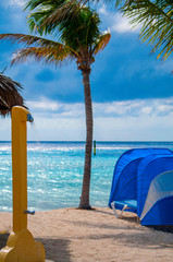 Grand Turk beach with palm trees and outdoor shower in the sand