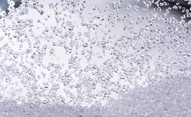 Obraz na płótnie Canvas Close up of crystal sugar in Glass bottles on white background.