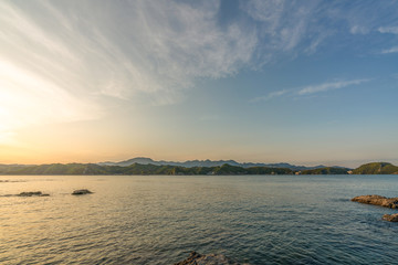 beautiful twilight sunset with blue sky high peak mountains mist fog green forest  park ocean sea idea for backpacker guiding backpacking camping campfire relax hiking  long weekend at Wakayama Japan