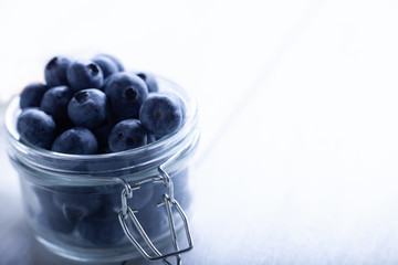 Beautiful blueberries in a glass jar.