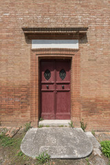 Fototapeta na wymiar Ancient red wood door and brick walls