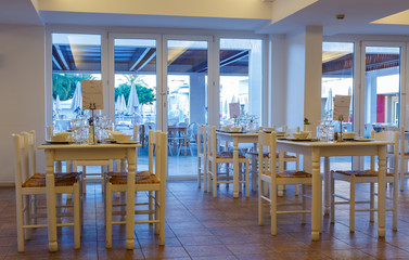 interior of traditional Greek restaurant with wooden white furniture, in bright colors, resort hotel, Rhodes, Greece, Europe