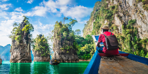 Panorama man traveler on boat joy nature rock mountain island scenic landscape Khao Sok National...