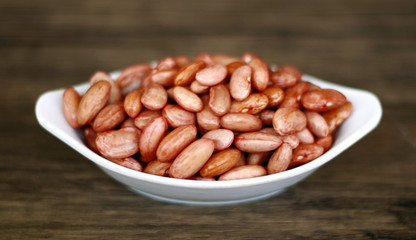 Red kidney bean on wood background.