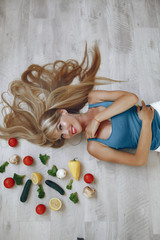 Naklejka na ściany i meble Healthy eating. Dieting and people concept. Blonde with a vegetable.