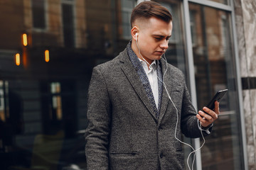 Handsome man in a black suit. Businessman working in a city