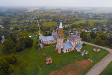 View of the old temple complex in the Parskoe village on a foggy September morning (aerial photography). Ivanovo region, Russia