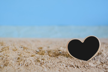 Fototapeta premium Heart sign wood with tropical sand beach ,love concept and soft focus.