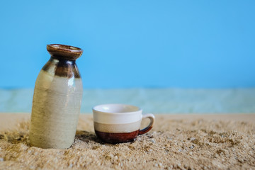 Breadfruit in bottle with tropical sand beach ,beverage concept.
