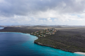 Fototapeta na wymiar Aerial view of coast of Curaçao in the Caribbean Sea with turquoise water, cliff, beach and beautiful coral reef around Playa Cas Abao