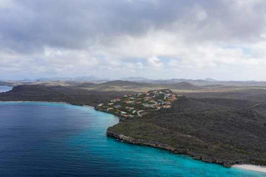 Aerial view of coast of Curaçao in the Caribbean Sea with turquoise water, cliff, beach and beautiful coral reef around Playa  Cas Abao