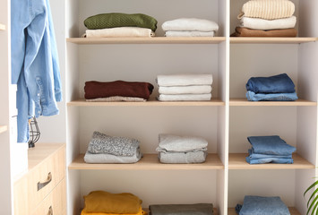 Wardrobe with stacks of clean clothes