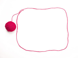 Red knitting yarn for handicrafts isolated on white background. Background of wool yarn, knitted...