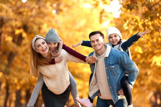 Portrait of happy family in autumn park