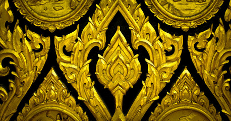 Closeup Thai pattern carving lotus picture at door in temple