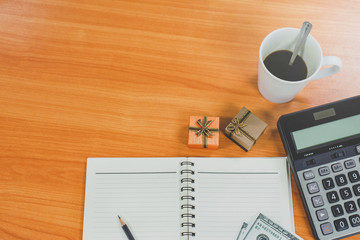 Calculators and gift boxes on the table. The concept of procuring Christmas presents for employees...