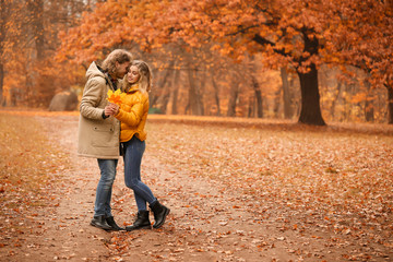 Young couple in park on autumn day