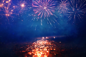 abstract gold, black and blue glitter background with fireworks. christmas eve, 4th of july holiday...