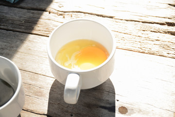 Onsen tamago egg or soft-boiled egg in white coffee cup.