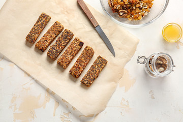 Tasty granola bars on table