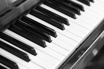 The keys of an old piano close up. Musical background black and white
