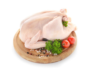 Raw chicken with spices and tomato on white background