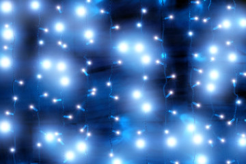 glowing christmas holiday new year blue glow background. Wide view of outdoor festive decoration with garland lights. New year celebration blurred backdrop design template