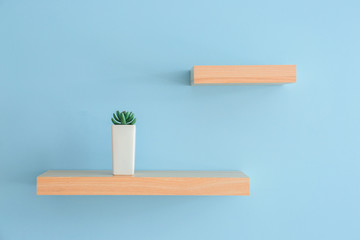 Shelves hanging on color wall