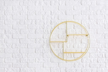 Empty shelf hanging on white brick wall