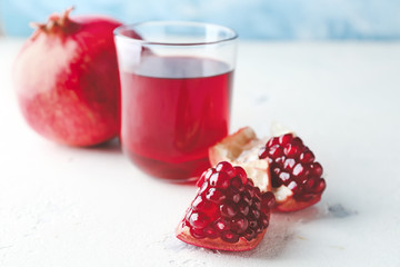 Glass of tasty pomegranate juice on table