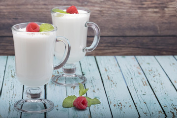yogurt in a glass with raspberries and mint