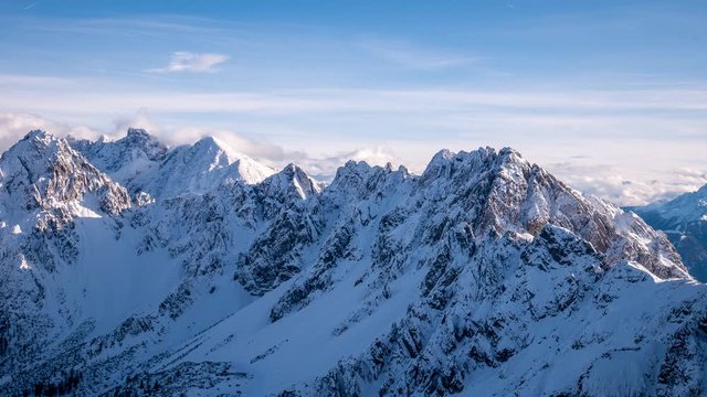 Timelapse with moving clouds above the snow-capped Wetterstein and Mieminger mountains 