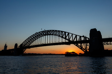 Fototapeta na wymiar Silhouette of Sydney Harbour Bridge viewed from Kirribilli at sunset