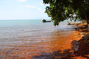 Traditional Khmer fishing boat anchored on the coast of Kep Cambodia that shows the beauty and everyday life of the country