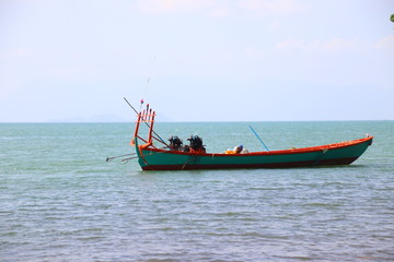 Naklejka na ściany i meble Traditional Khmer fishing boat anchored on the coast of Kep Cambodia that shows the beauty and everyday life of the country