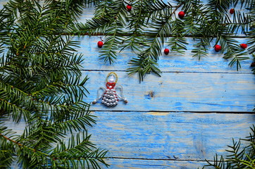 Christmas angel in composition on a blue background.